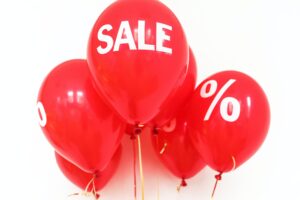 Red balloons with SALE and % on them